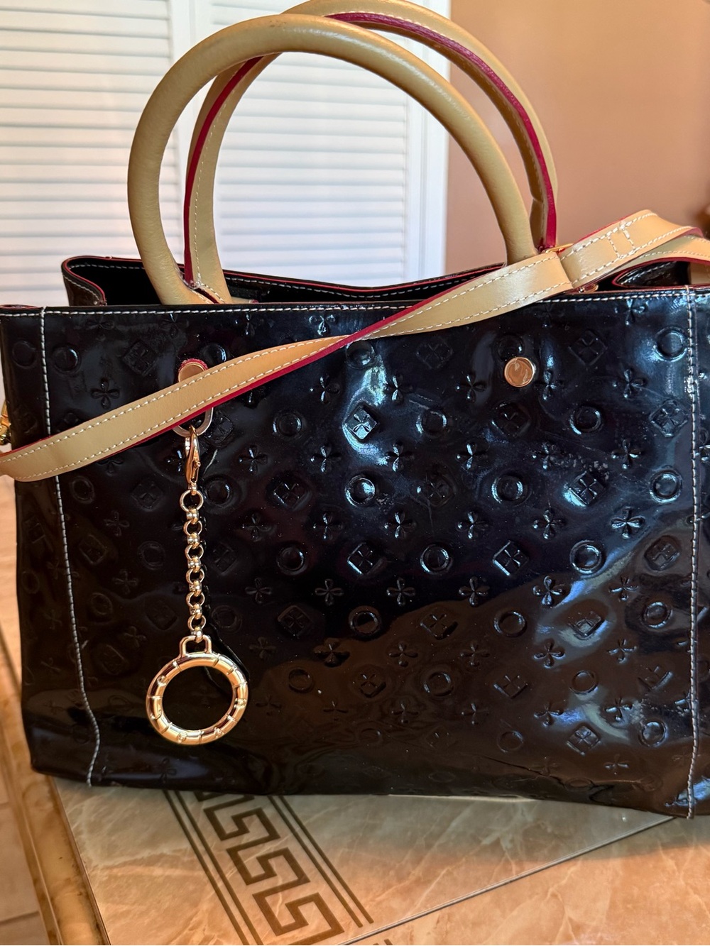 Glossy Black Patent Satchel with Beige Handles and Gold Chain Accent